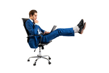 Poster - A man in a blue suit reclining in an office chair using a laptop, isolated on a white background, depicting remote work concept