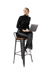 Leinwandbilder - A smiling woman seated on a stool, using a laptop, isolated on a white background, depicting a casual work concept