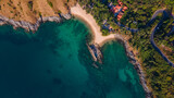 Fototapeta Na sufit - Beautiful beach with colorful water. Top view of the beautiful coastline. Sunny summer day. Colorful water. Sandy beach.	