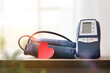 Blue digital blood pressure monitor on the table at home