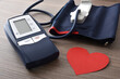 Blue digital blood pressure monitor for home on wooden table