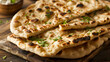 Stack of traditional naan bread on the table  with a sprinkle of fresh coriander leaves and cooked in tandoor ai generative