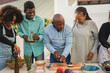 © Sabrina - Happy african family cooking together healthy dinner at house patio - Parents and adult children preparing food outdoor
