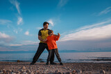 Fototapeta Sypialnia - Father and son training on the lake shore