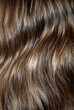 Photo of brown shiny and wavy hair, close up, details