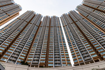 Canvas Print - Bottom view of residential building in Hong Kong city