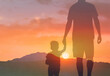 Father's and his son holding hands walking at sunset . Dad leading son over summer nature outdoor. Family, trust, protecting, care, parenting concept