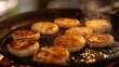 Close-up of delicate Thai coconut pancakes, or 'Khanom Krok,' sizzling on a hot griddle.