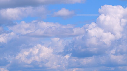 Wall Mural - Dramatic moving white cumulus and cirrocumulus clouds or puffy fluffy cloudscape on beautiful sunny blue sky. Time lapse.