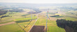 Aerial view of two modern windmills between the fields in the german countryside