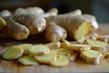 Fototapeta Kwiaty - Fresh ginger root and sliced pieces, known for its anti-inflammatory and digestive properties. Zingiber officinale.