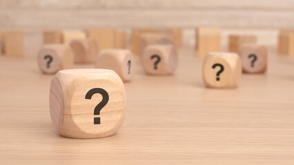 Wall Mural - wooden cubes with a question mark engraved on them, front view