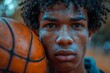 © Larisa AI - A young basketball player with sweat glistening on his face holds the basketball close, his gaze fixed