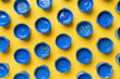 Multitude of Blue Plastic Cups Splattered with Blue Paint on Yellow Background