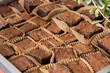 Large selection of delicious brownies cut in perfect squares to eat by hand