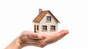 hand holding a small house on a white background - real estate concept