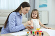 © New Africa - Mother and her little daughter painting with palms at home