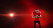 Image of excited american football player holding ball on red background with pulsing light