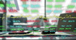 Digital composite image of stock market data processing against office equipment on desk