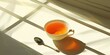 Spoon and glass hold sunlit tea.