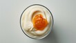 Top angle shot of rich and creamy yoghurt with a dollop of apricot jam, demonstrating exquisite smoothness and sheen, captured in raw photo style with a clarity of 150, on a clean isolated background