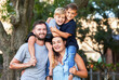 © peopleimages.com - Portrait, mom and dad with kids in bonding as family in outdoor for together, happy and cheerful. Parents, children and hug with boys as brothers in garden at home for connection, love and support