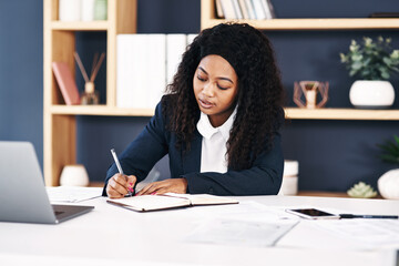 Writing, black woman or lawyer at law firm with document, form and planning in office for feedback review. Legal, diary or attorney with notes on information, schedule or reminder for working on case