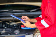 Car garage with red suit and chart for repair car engine.