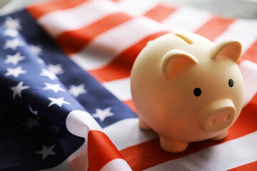 Sticker - Closeup view of an American flag with a pink piggy bank for various financial concepts.