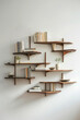 A series of modern wall-mounted shelves with clean lines and minimalist design, arranged in a staggered formation on a plain wall, offering stylish storage solutions for books, decor, and more. 