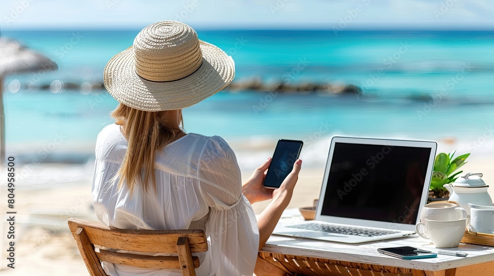 A woman is sitting on a beach chair with a laptop