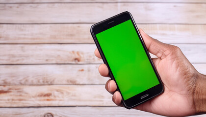 Poster - Closeup of a hand holding an smart phone with a picture of green screen