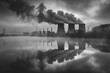 An atmospheric shot of steam rising from the cooling towers of a power plant with the structures reflection mirrored in a tranquil body of water 