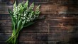 Fresh lily of the valley bouquet on rustic wooden background