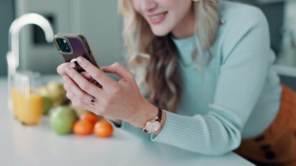 Canvas Print - Happy, woman and typing on phone in kitchen with fruit for recipe on healthy, nutrition and detox juice in the morning. Smile, female person and reading online for smoothie for organic breakfast