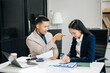 © laddawan - Furious two Asian businesspeople arguing strongly after making a mistake at work in modern office