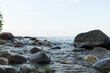 Summer evening on a lake shore with big stones