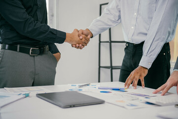Poster - Three men shake hands in a business meeting