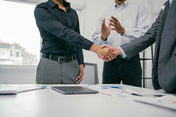Poster - Three men shake hands in a business meeting
