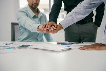Poster - Three men are shaking hands in a business meeting