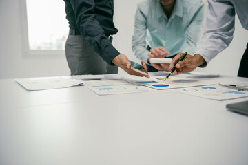 Aufkleber - Three men are sitting at a table with papers and a cell phone