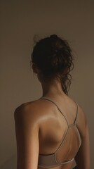 Wall Mural - A woman with a ponytail and a backless top