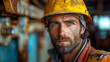 © T-elle - Portrait of a focused industrial worker in a factory setting, wearing a hard hat and a serious expression amidst machinery