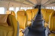 © sceneperfect - An empty airplane cabin with yellow seats. The seats are arranged in a 3-3 configuration.