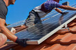 © Hermann - Dachdecker beim Aufbau einer Photovoltaikanlage auf einem neu gedeckten Ziegeldach: Verschraubung der Solarmodule an den Endklemmen des Schienensystems am Dachrand