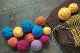 Fototapeta Uliczki - Balls of wool and knitting needles on rustic table. Copy space