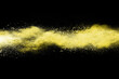 abstract powder splatted background. Freeze motion yellow powder explosion on black background