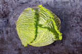 Fototapeta Uliczki - Head of Savoy cabbage on old metal sheet