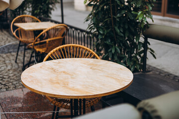 Outdoor street cafe tables ready for service. Modern Empty cafe terrace with table and chair, morning time. Food concept. Cafeteria, Outside Trattoria