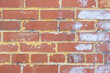 Brick wall with remnants of peeling paint